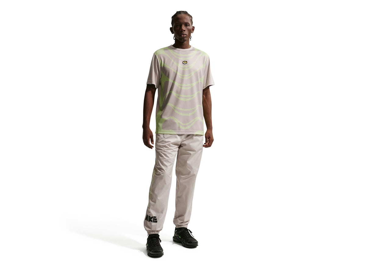 Nike Windrunner Woven Graphic Pants in Moon Particle / Cream Li / Volt